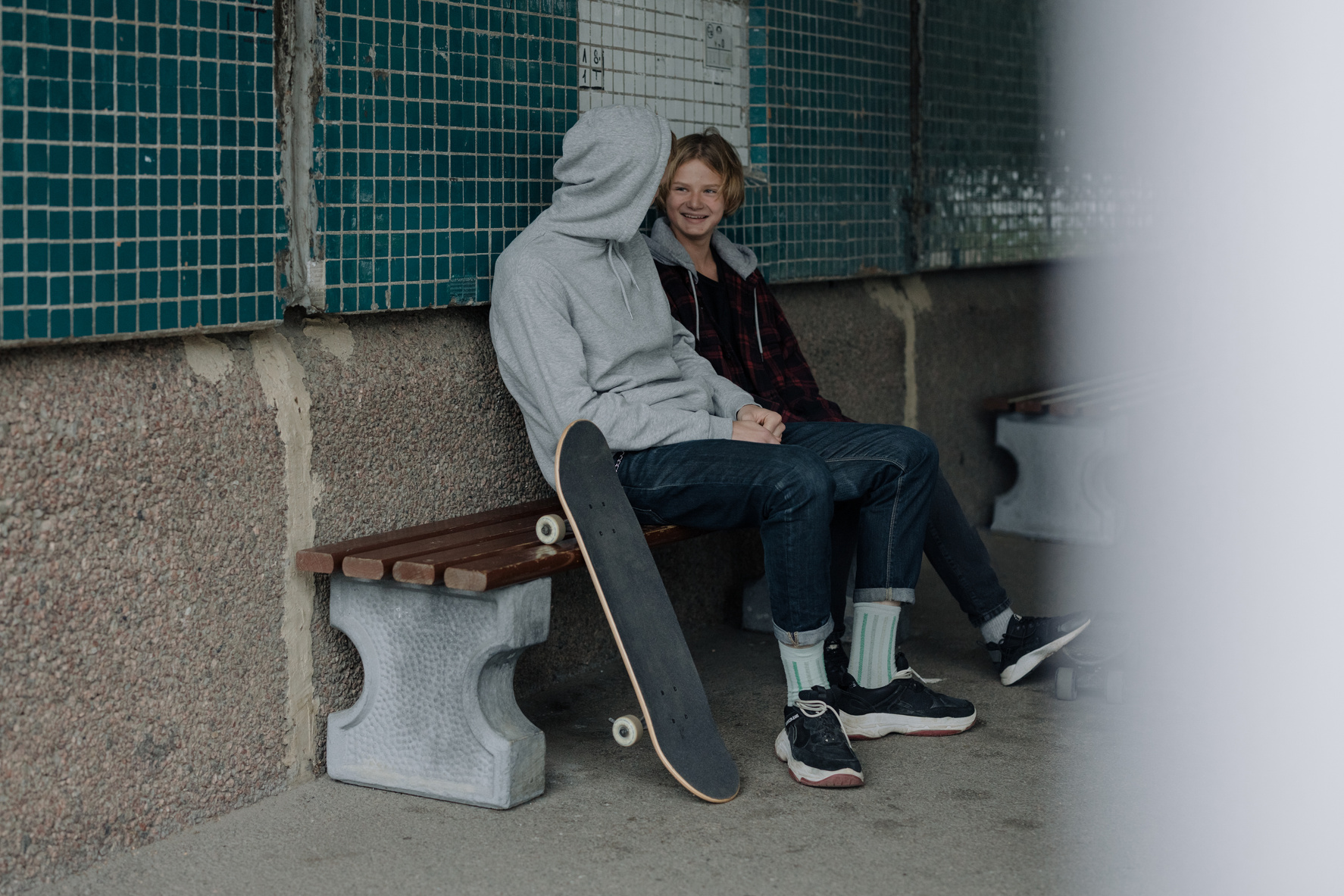 Two People Talking While Sitting on Bench